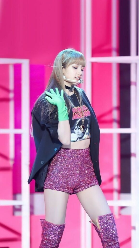 Lisa from Kpop girl group BlackPink Performing with bold green gloves and fashionable shorts