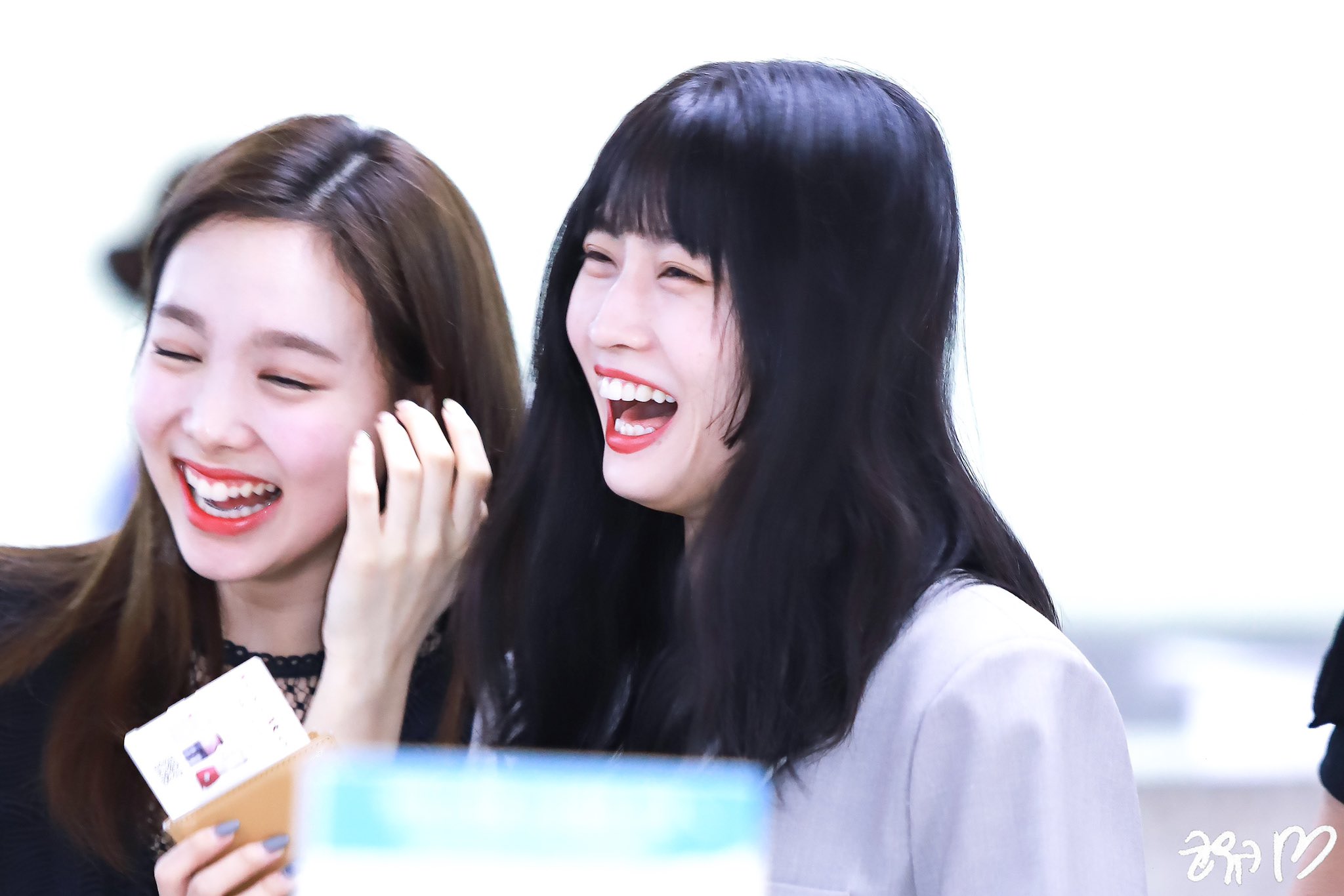 Momo laughing with her group mate Nayeon